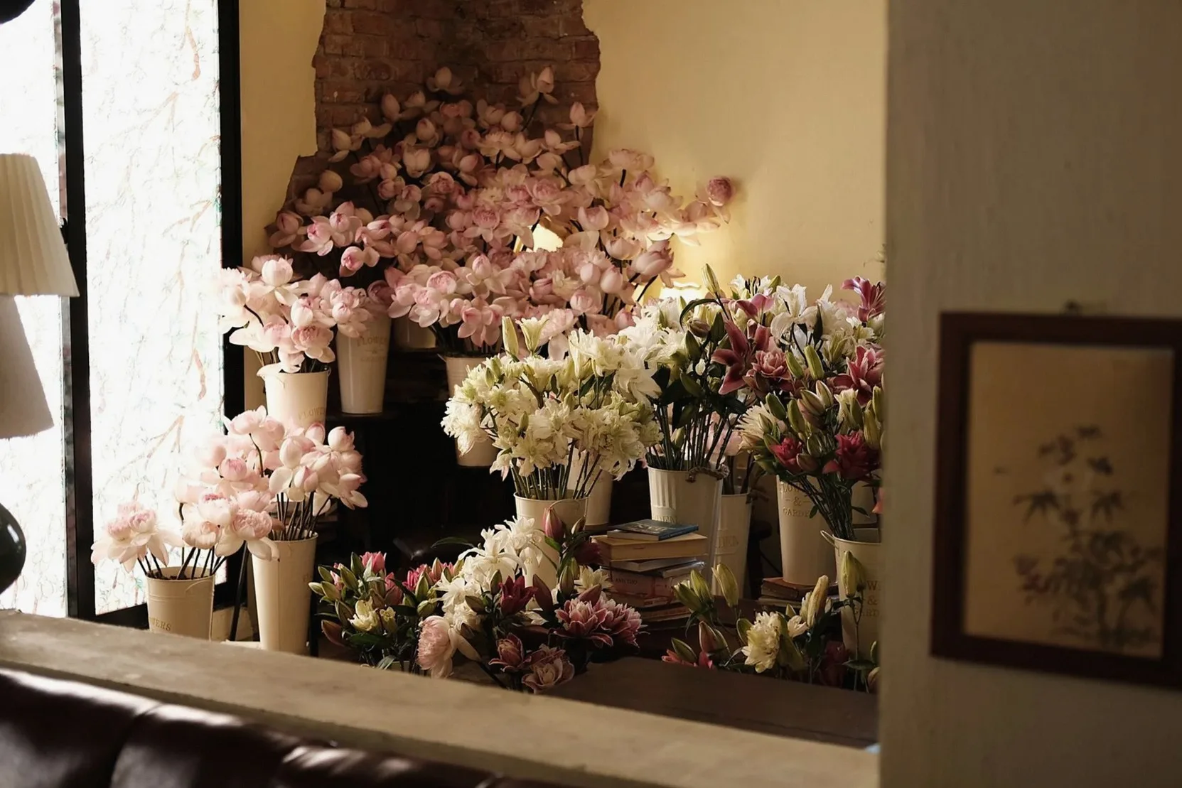 Interior of a cozy Vietnamese florist shop filled with various colorful flowers in vases, creating a warm atmosphere.